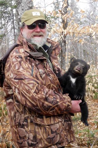 Don holding bear cub